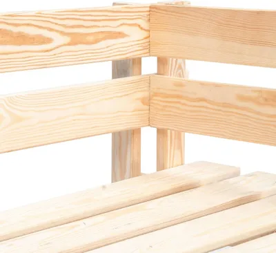 A close-up view of the corner joint of a wooden outdoor corner bench.