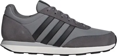 A side view of a gray and black Adidas sneaker against a white background.