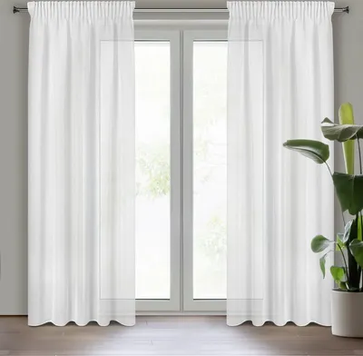 A pair of white curtains hanging in front of a window.