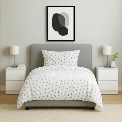 A bedroom scene with a bed, nightstands, and a picture frame.