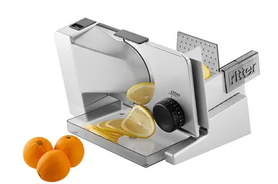 A silver electric slicer with lemons being sliced and oranges nearby, on a white background.