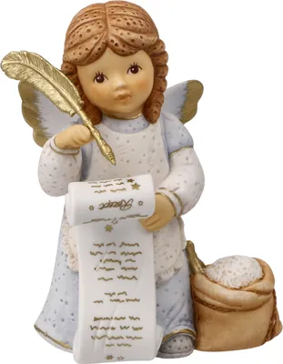 A ceramic angel figurine holding a quill and a scroll, with a sack of flour next to it.