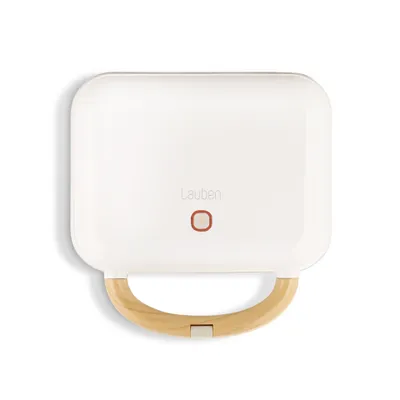 A top-down view of a white sandwich maker with a wooden handle.