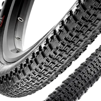 Close-up view of a bicycle tire with a detailed tread pattern.