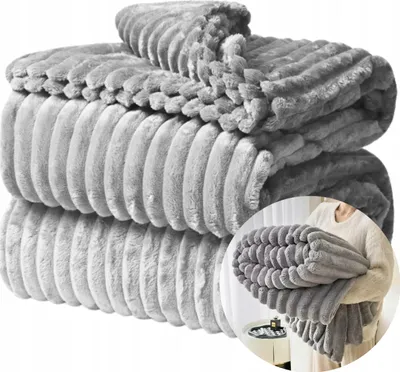 A person is holding a folded blanket.