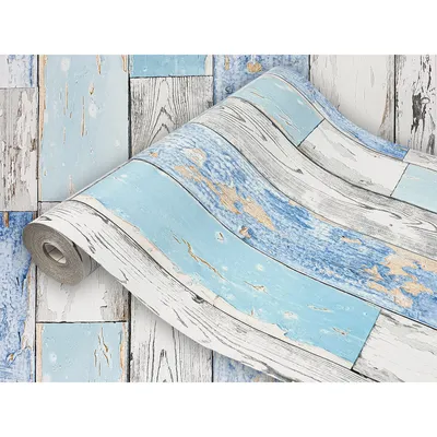 A roll of wood-effect wallpaper with a distressed blue and white finish.