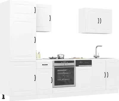 A white kitchen cabinet set with appliances.