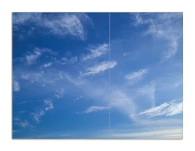 Produktbild von Wallario Herdabdeckplatte aus Glas, Größe 70 x 52 cm 2-teilig, Motiv Blauer Himmel mit vereinzelten Wolken