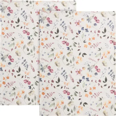 Two kitchen towels with a floral pattern are laid out side-by-side.