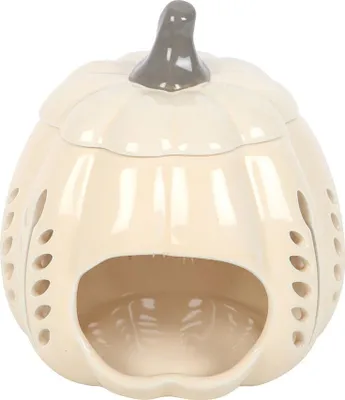 A cream-colored ceramic pumpkin-shaped oil burner with cut-out leaf designs and a gray stem, shown against a white background.