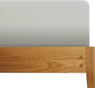 A close-up view of the headboard of a bed, showing the wooden frame and the fabric headboard.