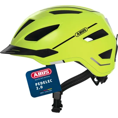 A bright yellow bicycle helmet with black accents and a black visor, shown from a diagonal angle against a white background. A blue tag with product information is attached to the helmet strap.