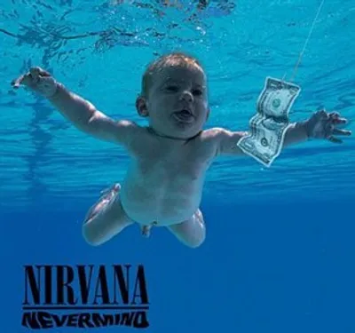 A baby swimming underwater reaching for a dollar bill, with the album title and band name below.
