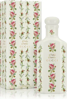 A product shot of a Gucci perfume bottle and its box, both decorated with a floral pattern.