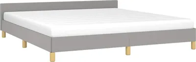 A plain studio shot of a bed frame with a mattress.