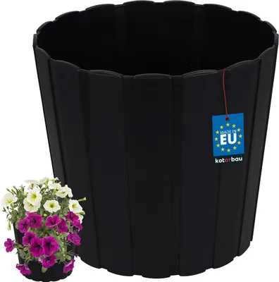 A black flower pot with a small cluster of petunias in front of it.