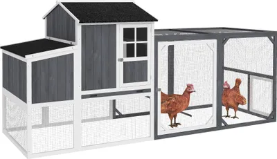 A wooden chicken coop with an attached run, featuring two chickens inside the run.