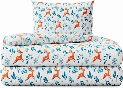 A stack of bedding with a Christmas-themed pattern of deer and foliage.