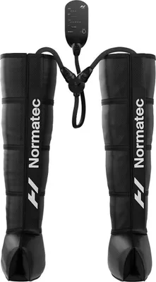 A pair of black compression boots with a control unit connected by tubes, shown against a white background.
