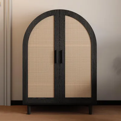 A black arched cabinet with rattan doors and three shelves, standing on four legs.