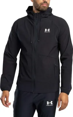 A man wearing a black Under Armour jacket and pants.