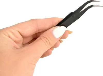 A hand holding a pair of tweezers.