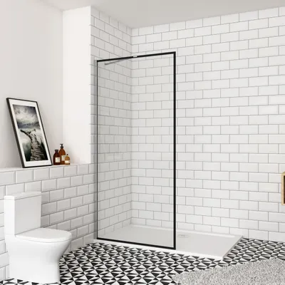 A modern bathroom with a toilet, shower enclosure, and tiled walls and floor.