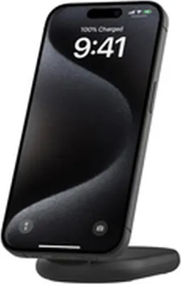 A black wireless charger with a phone on it, showing the time and battery status.