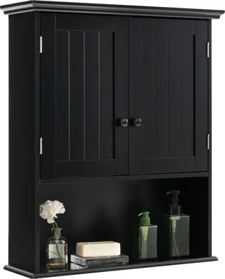 A black wooden bathroom cabinet with two doors and an open shelf below, decorated with a flower in a vase, a bar of soap, and two soap dispensers.