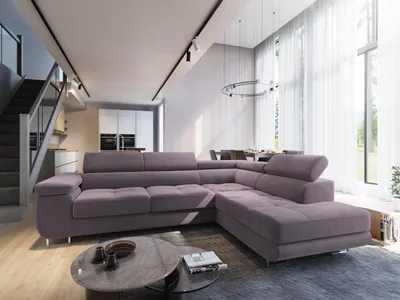A modern living room with a large sectional sofa, dining table, and staircase.