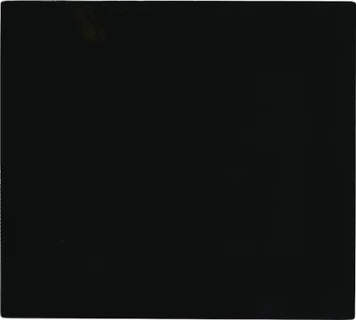 A black glass plate, likely a stove top cover or splashback.