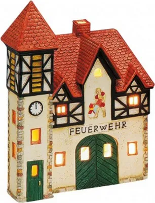 A decorative ceramic fire station building with lights.