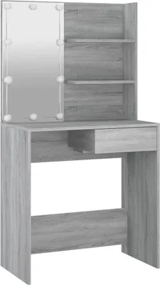 A vanity table with a mirror and shelves.