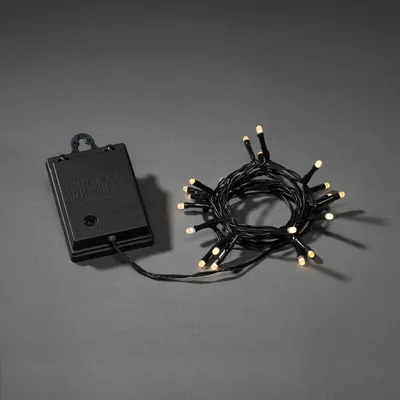 Immagine prodotto di Fata LED Konstsmide, con interruttore on/off, con sensore di luce e timer 6h e 9h, smerigliata, 20 diodi bianco caldo, a batteria, per esterni (IP44), cavo nero, batteria: 4 x AA 1,5V (escl.) - 3722-130