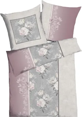 A flat lay of bedding and pillowcases with a floral pattern.