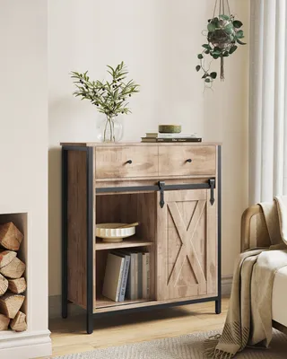 A wooden sideboard with a sliding barn door, placed in a room with a fireplace and a hanging plant.