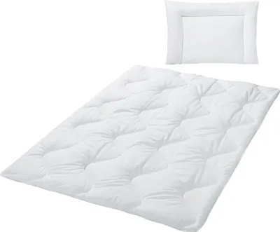 A white duvet and pillow set on a white background.