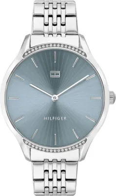 A close-up studio shot of a silver Tommy Hilfiger women's watch with a blue sunray dial.