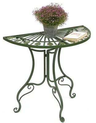 A green metal half-round table with a potted plant and a book on it, set against a white background.