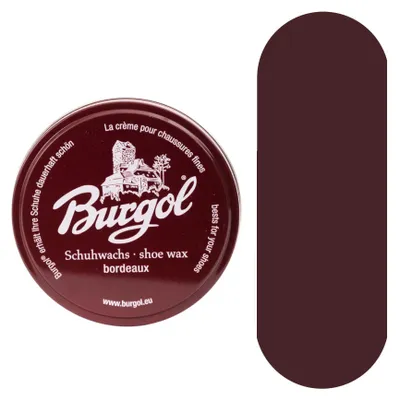 A tin of shoe wax and a color swatch.