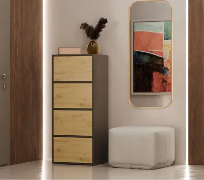 A modern hallway with a tall chest of drawers, a mirror, and a pouf.