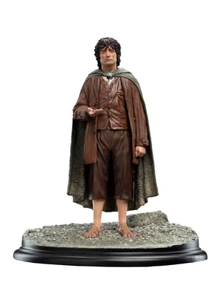 A statue of Frodo Baggins from The Lord of the Rings, standing on a rocky base.