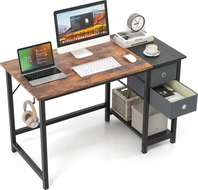 A desk setup with a laptop, monitor, keyboard, mouse, headphones, and storage drawers.