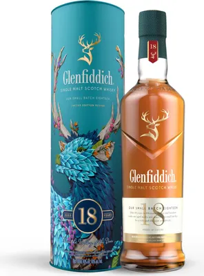 A bottle of Glenfiddich 18 Year Old Single Malt Scotch Whisky with its decorative cylindrical packaging.