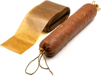 A roll of brown casing material and a sausage are displayed on a white background.