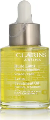 A bottle of Clarins Lotus Face Treatment Oil with a dropper.