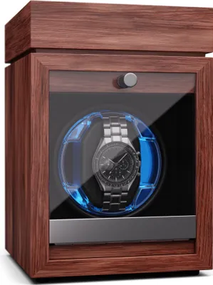 A watch winder with a watch inside, set against a white background.