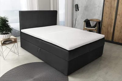A modern bedroom with a boxspring bed.