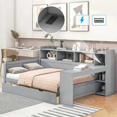 A modern gray daybed with built-in storage, desk, and shelves, set in a bedroom with a desk and artwork in the background.