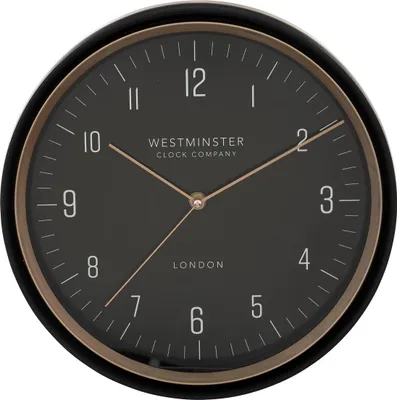 A close-up view of a black wall clock with gold accents.